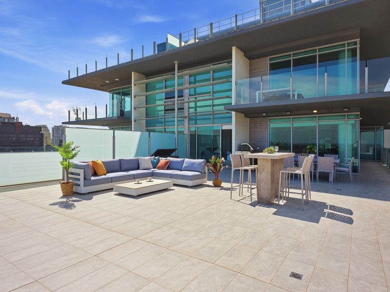 Expansive rooftop terrace with stylish outdoor seating and panoramic views.