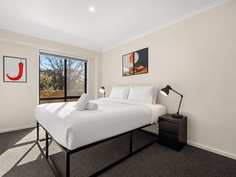 Comfortable bedroom with crisp linen and plenty of natural light.