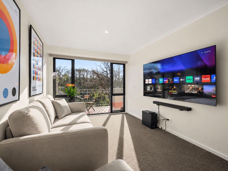 Bright and stylish living space with Smart TV and balcony access
