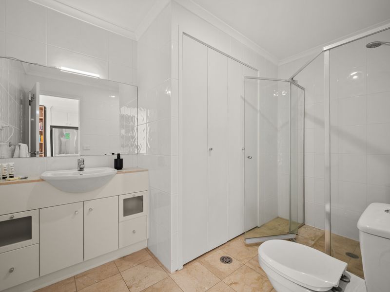 Large bathroom and spacious glass-enclosed shower.