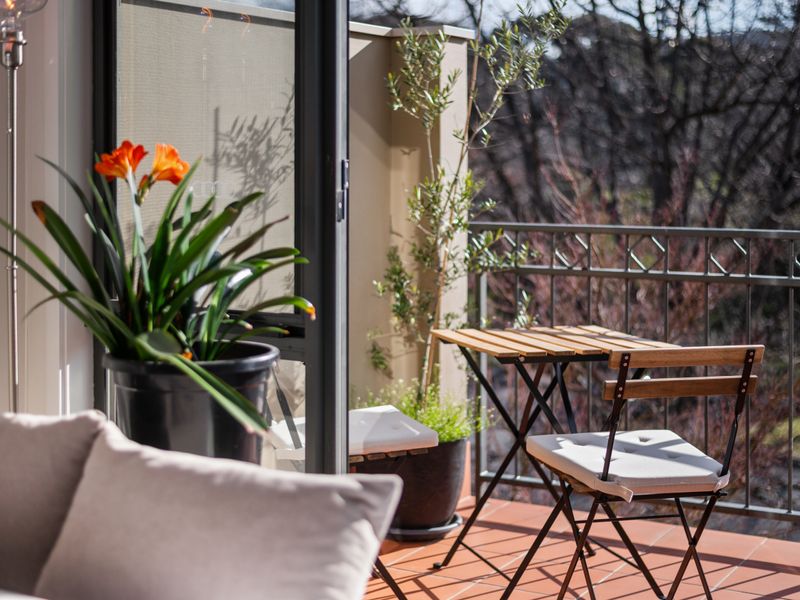 A peaceful balcony nook overlooking the leafy surrounds.
