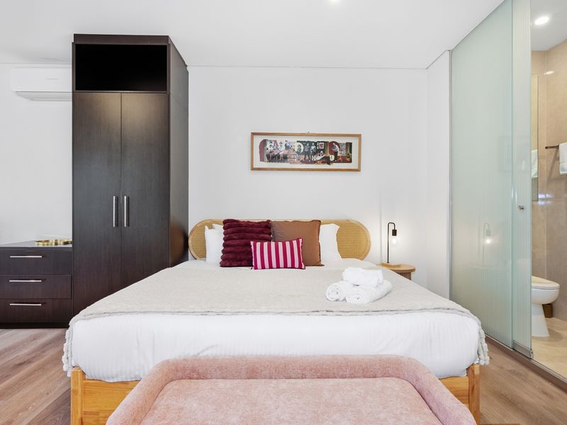 Comfortable Kingbed with wardrobe storage and soft lighting.