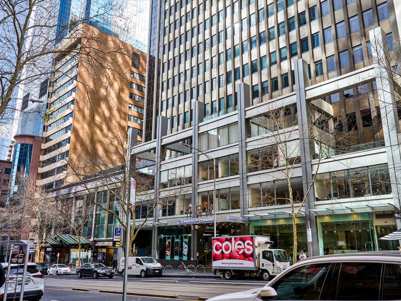 Street view showcasing the surrounding commercial buildings and city traffic.