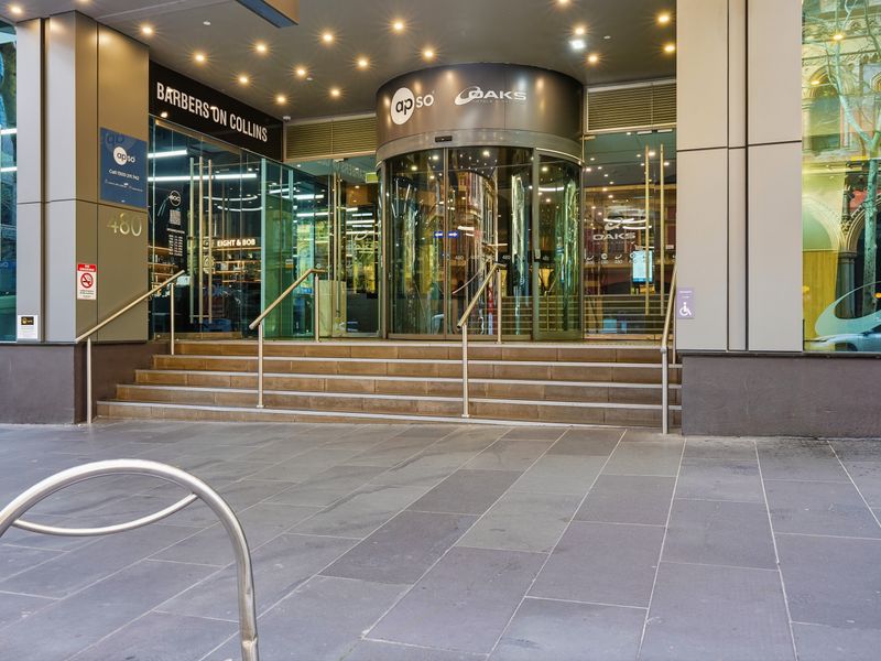 Exterior street-level view of the building entrance with steps.