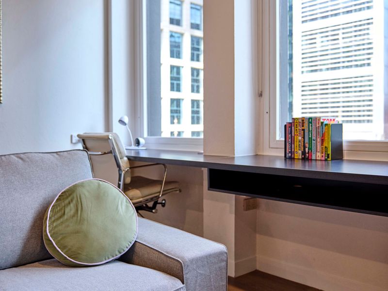 Dedicated desk setup with a chair positioned by the window.