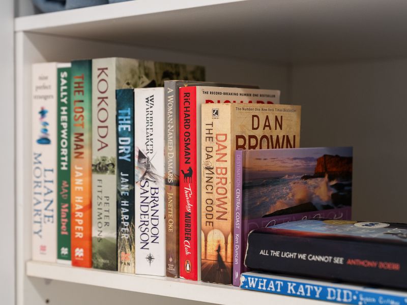 Bookshelf display featuring an organized collection of novels and paperbacks.