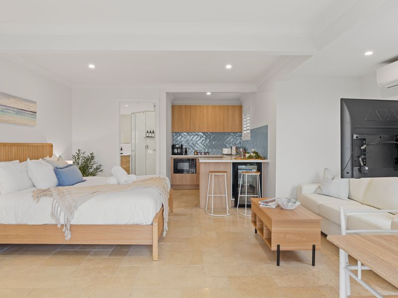 Wide-angle interior perspective showing the bedroom layout connecting to the main living areas.