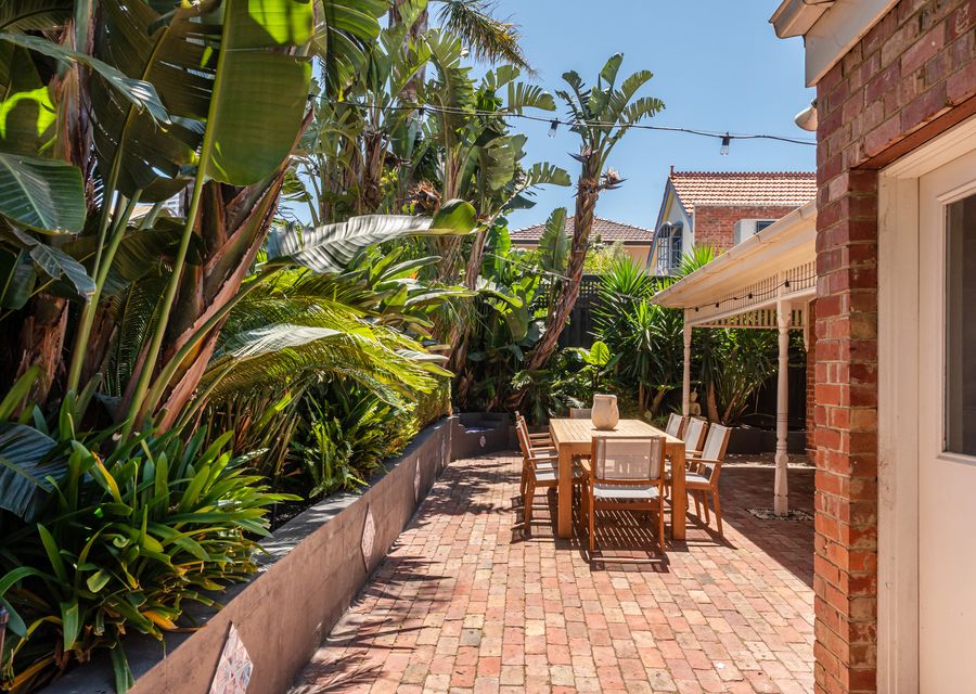 Outdoor courtyard with dining and festive lighting