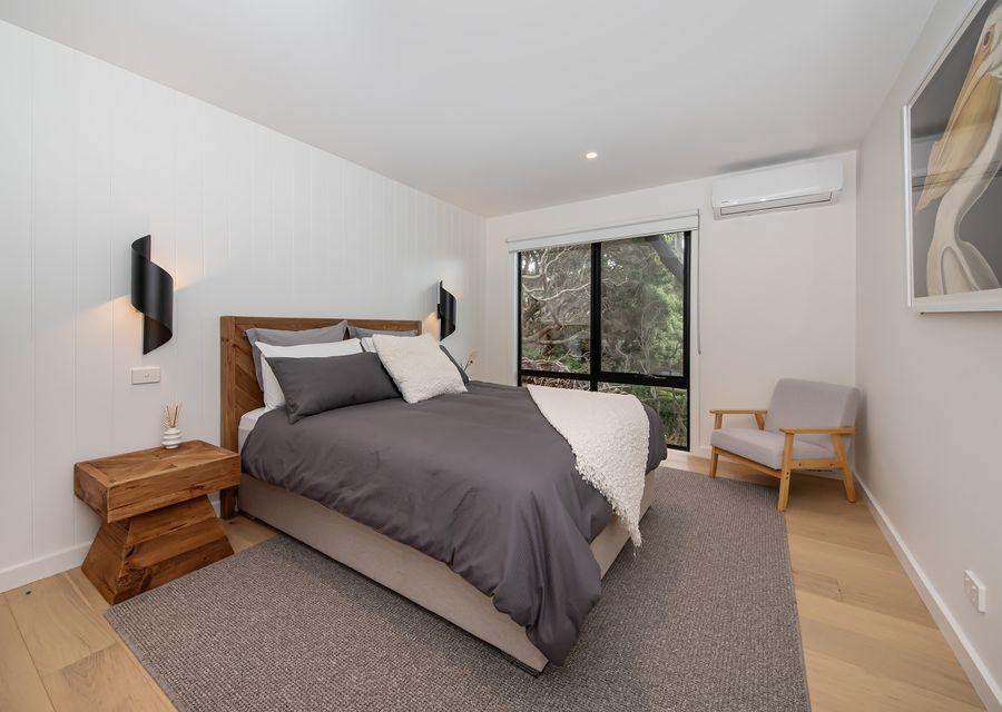 Bedroom two with queen bed and air con 