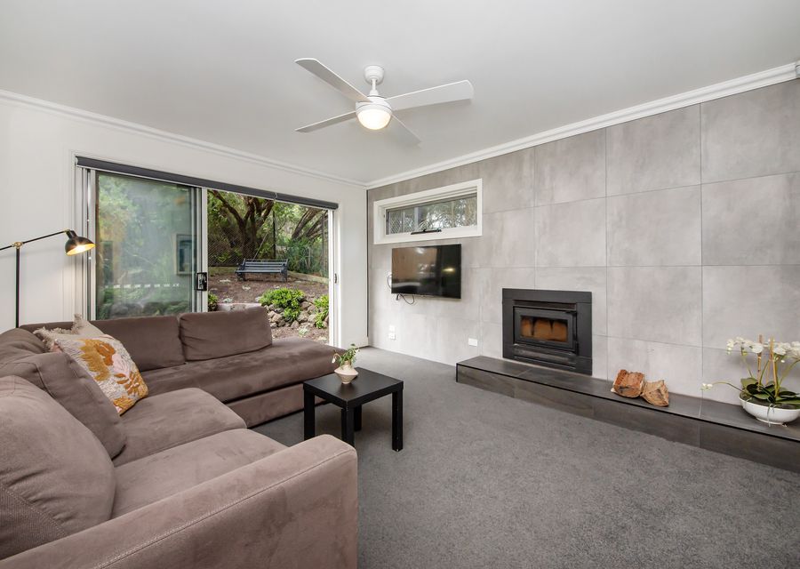 Downstairs living area with fireplace. Leads out to outdoor entertaining area 
