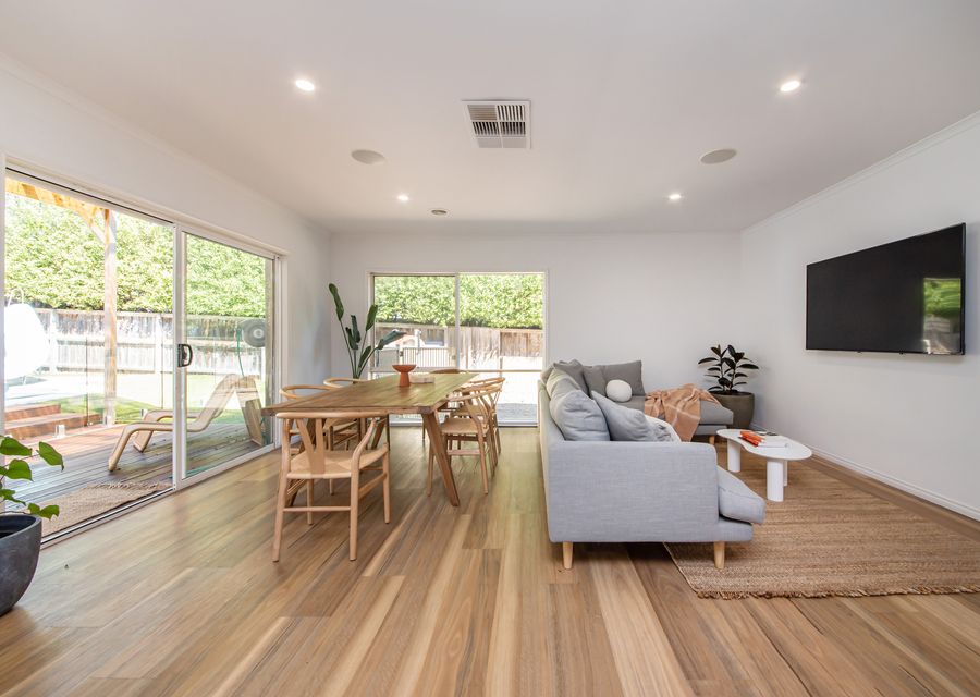 Living and dining with smart TV and looking out over pool