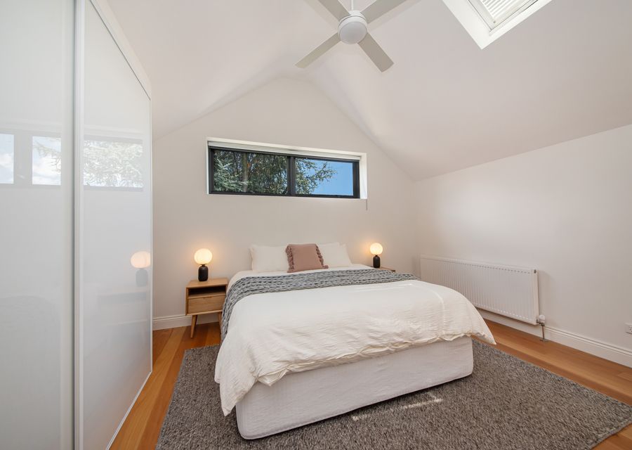 Bedroom 2 upstairs with ceiling fan and hydronic heating