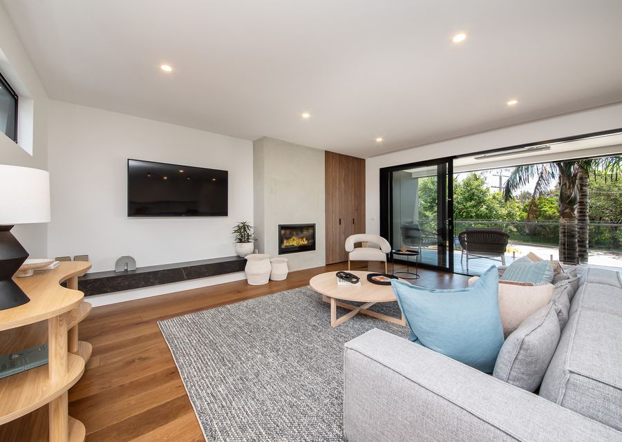 Living area with gas fireplace leading out to balcony 