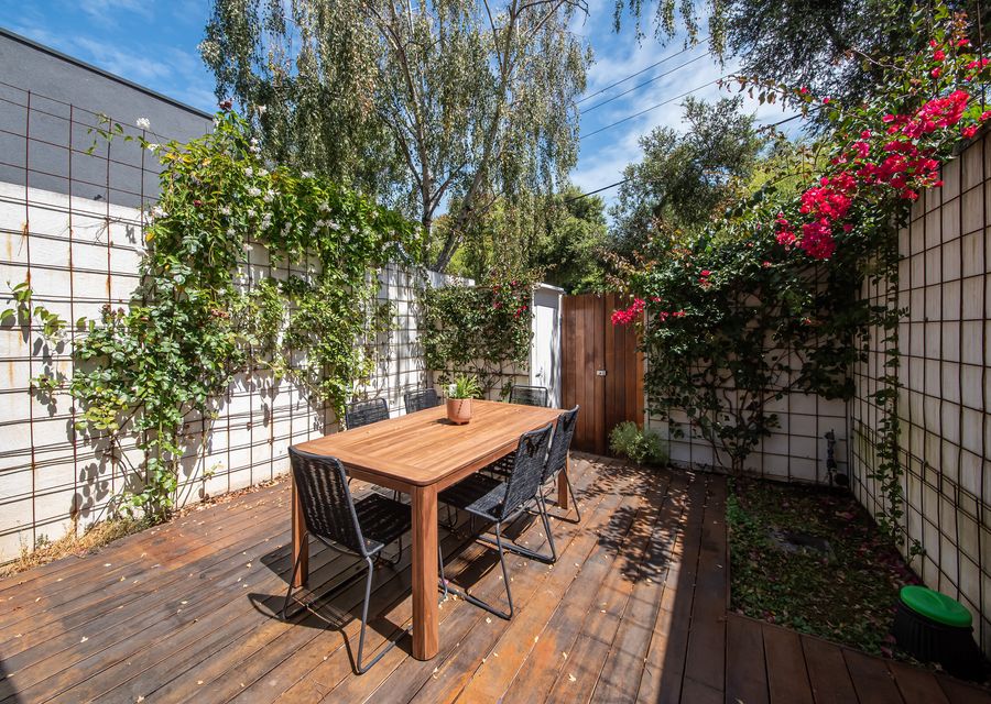Outdoor sitting area surrounded with a little gardenare