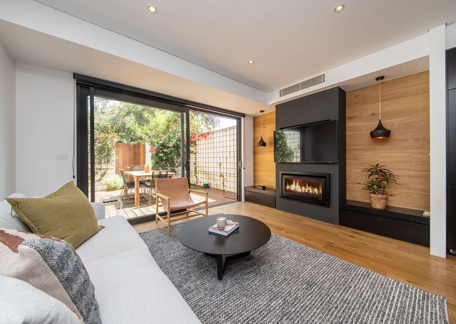 Stunning living space with gas fireplace, smart tv and leading to courtyard