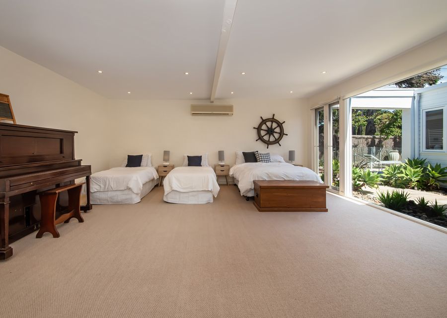 Nautical Style bedroom 4 with 1 double bed and 2 single beds and has a nice view of outdoor.