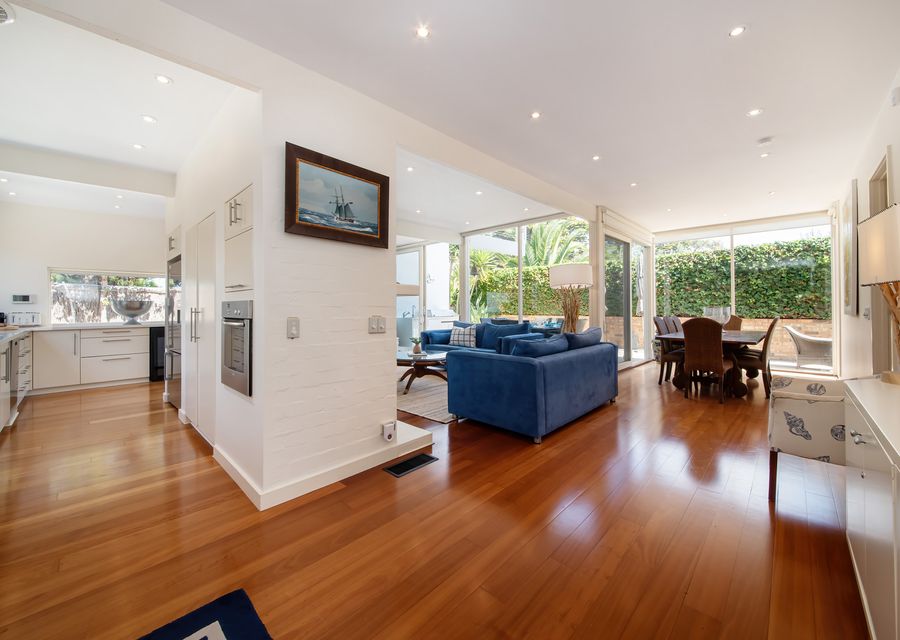 Living room and dining room area, with a sneak peak of the kitchen. 