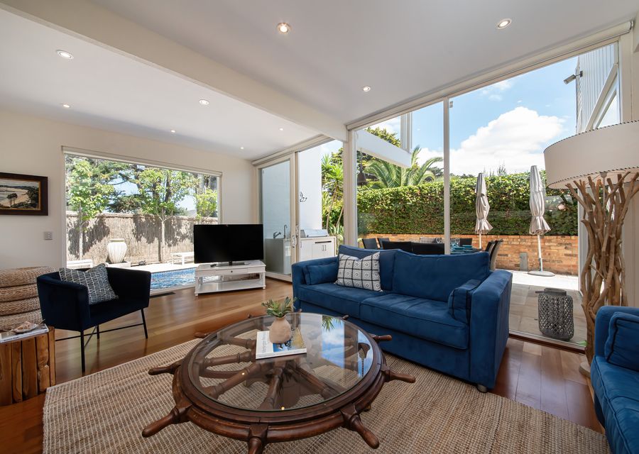 Living room area featuring a nice Smart TV and a view of the pool