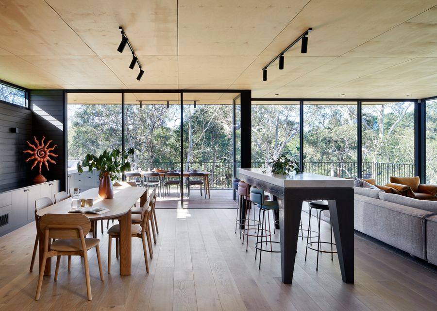 Large living area with stunning views to trees and the bay