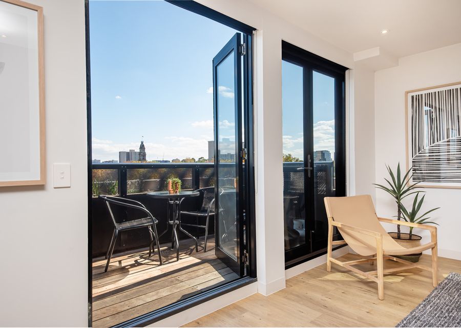 Large glass balcony doors to outdoor seating
