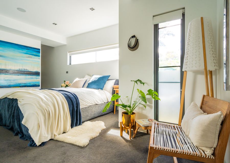 The master bedroom has a queen bed and seating area