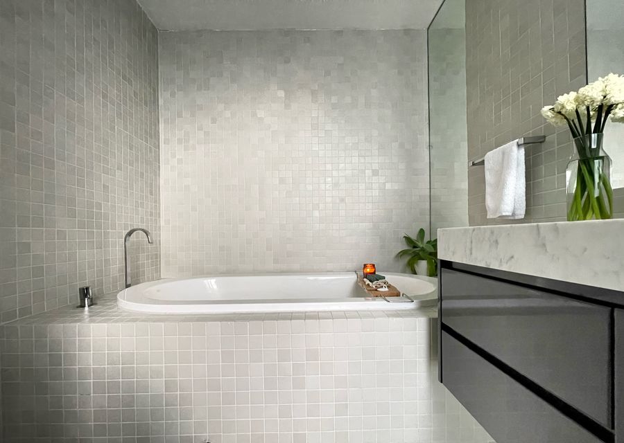 Main bathroom with built in bath , single vanity and walk in shower