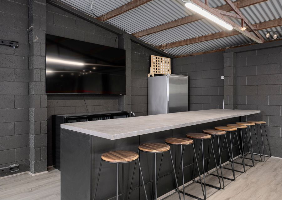 Smart TV and fridge in the hockey table area as well