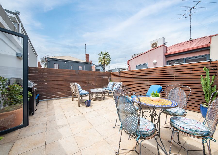 Spacious outdoor balcony off the living space with seating and bbaq