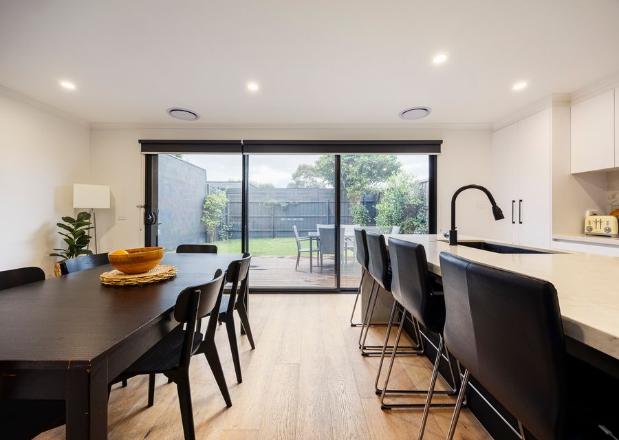 Dining with seating for 6, kitchen and rear yard access