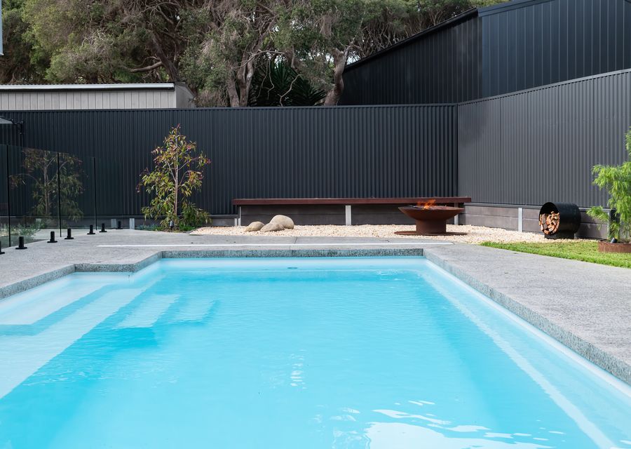 Spacious backyard with a pool  and firepit