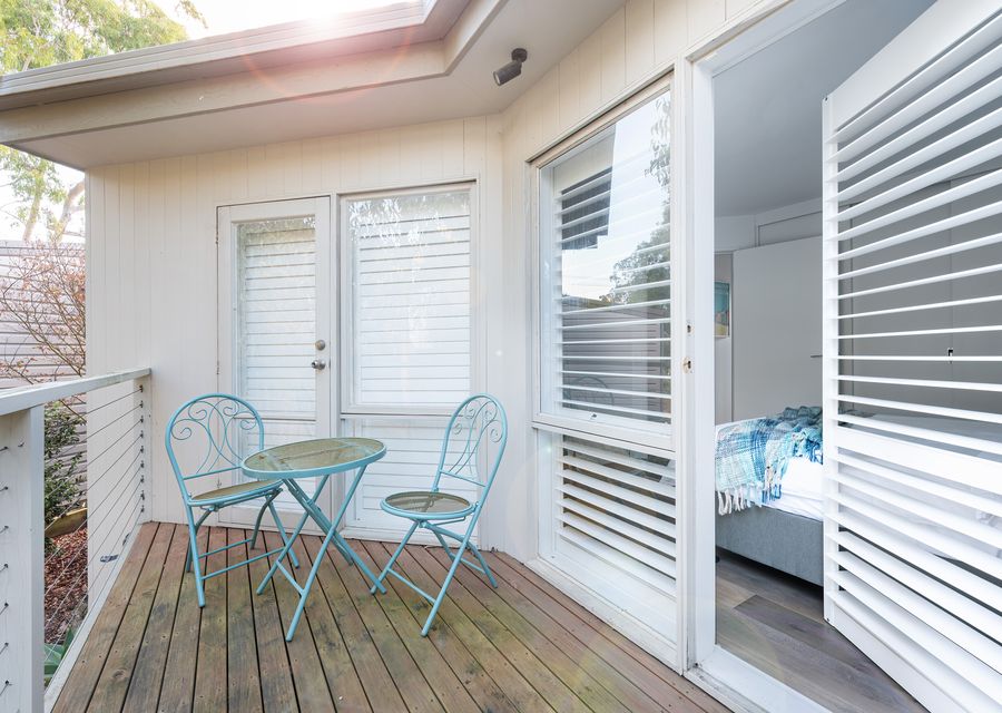 Bedroom two with a balcony and seating area 