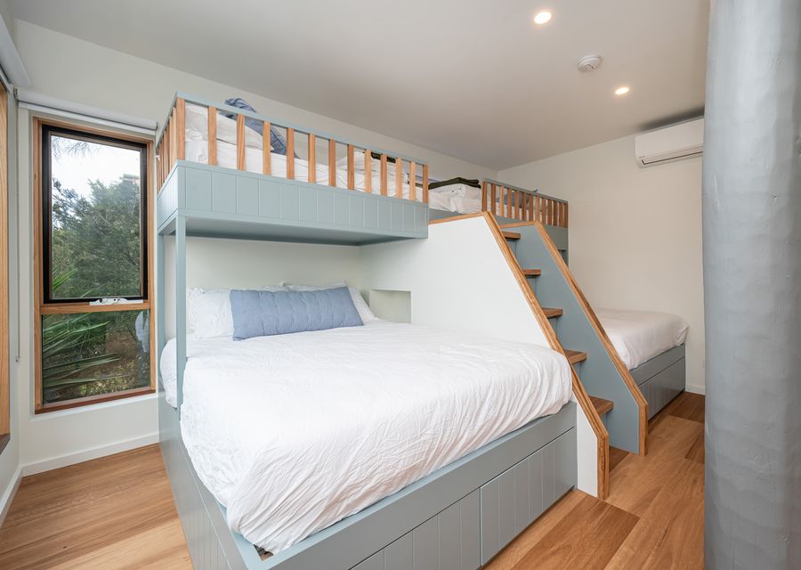 Bedroom four with external access with two queen bunks with king single above. Sleeping 6. with ensuite and air conditioning and access to the heated spa 