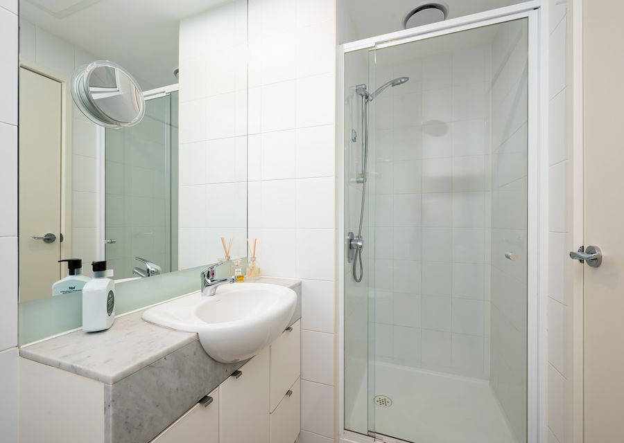 ensuite bathroom with step in shower and single vanity