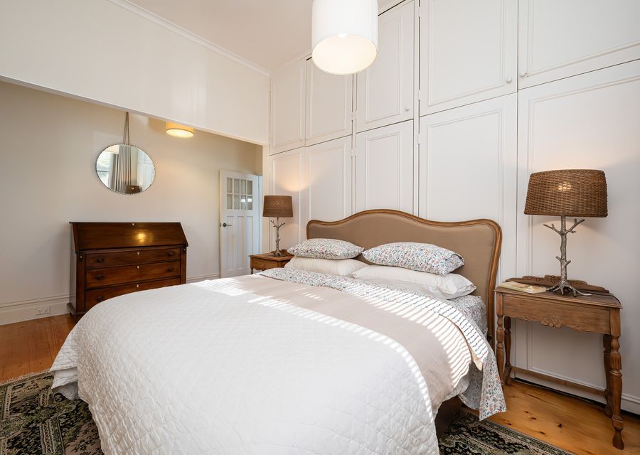 Bedroom with queen bed with access through to living room 