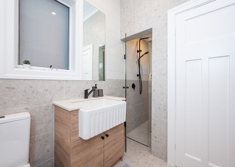 2nd bathroom with shower, single vanity, toilet and Euro laundry