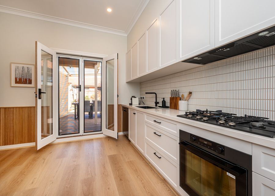 Fully equipped kitchen with glass doors leading out to the courtyard