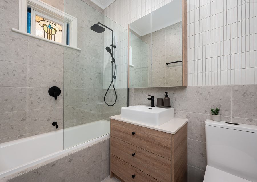Family bathroom next to Master bedroom with shower over bath, single vanity and toilet
