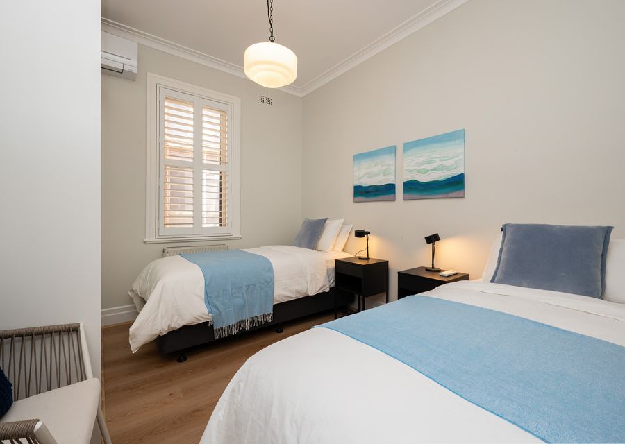 Bedroom 2 with 2 single beds and split system for heating and cooling