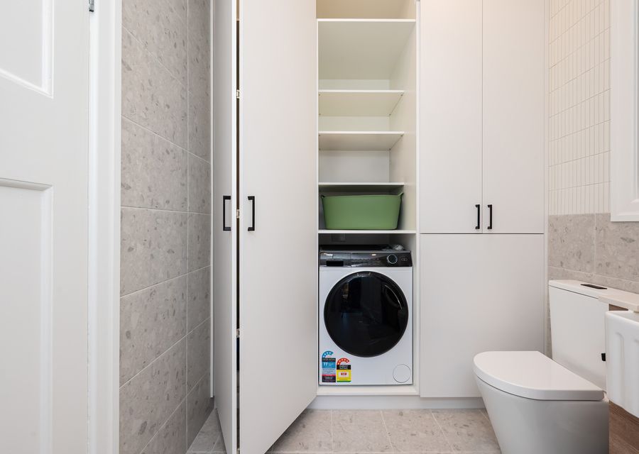 Second bathroom with shower and toilet and Euro Laundry -washing machine / dryer combi. 