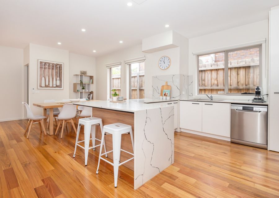 Fully equipped modern kitchen with stone benchtop and quality appliances