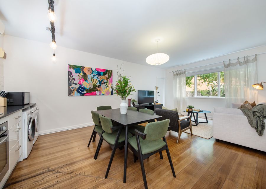 Laundry at the end of the kitchen with washing machine and separate dryer