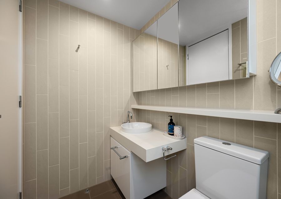 Ensuite with walk in shower, single vanity and toilet