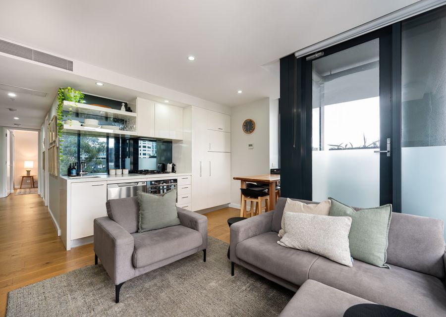 Open plan living with access to small step on balcony space