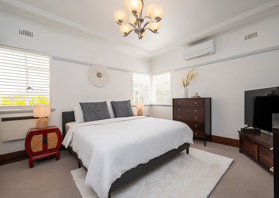 Bedroom one with king bed and TV