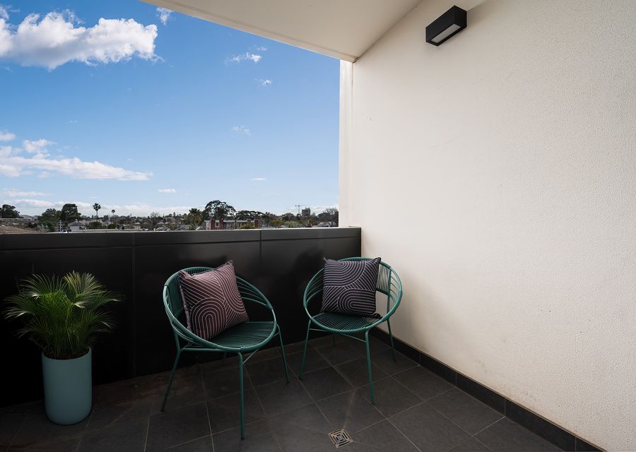 Outdoor covered balcony with seating for 2