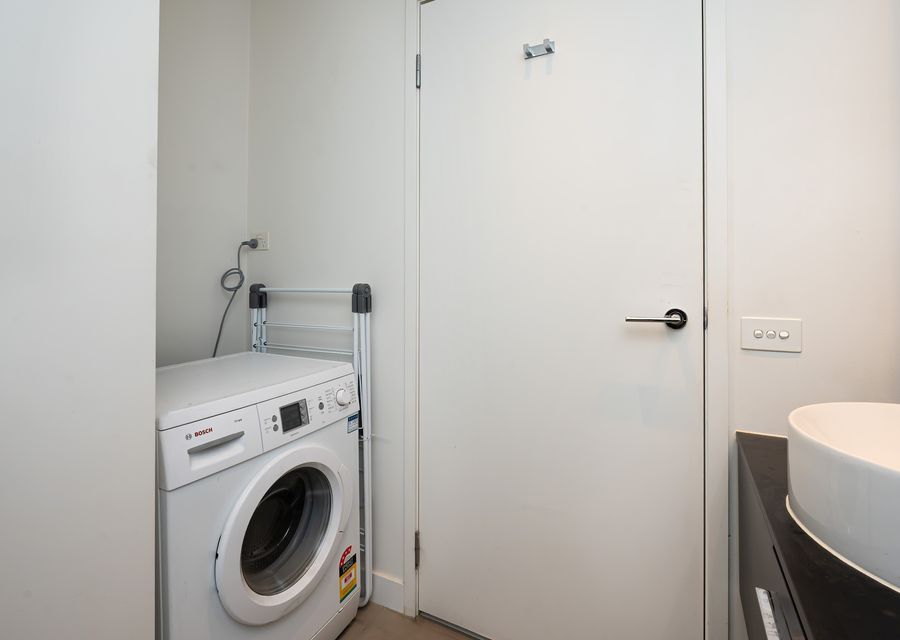 Laundry with washing machine located in bathroom