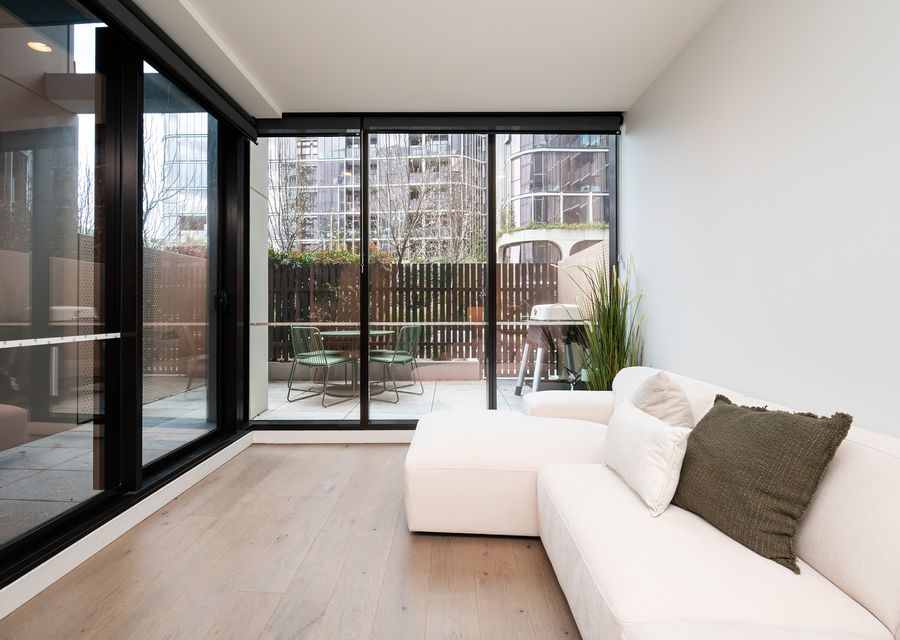 Living room onto blacony sapce through large glass doors