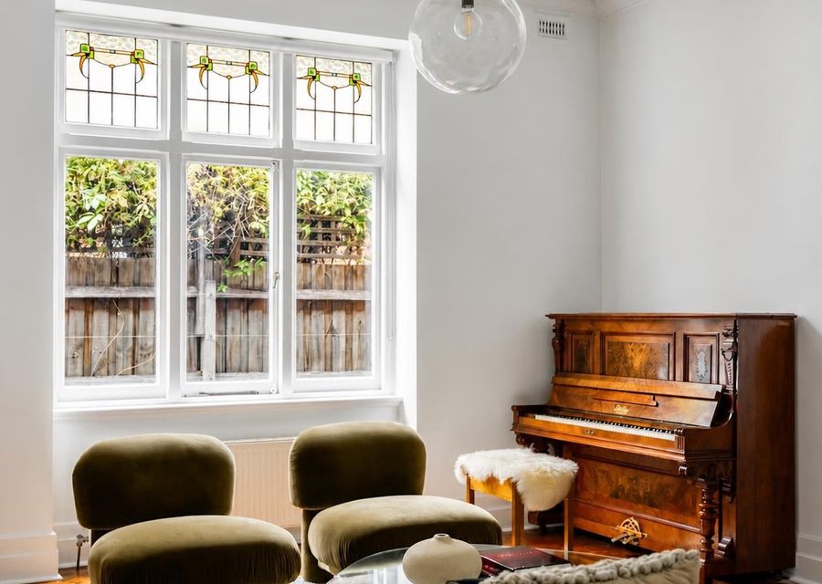 Elegant living space with beautiful original windows and piano