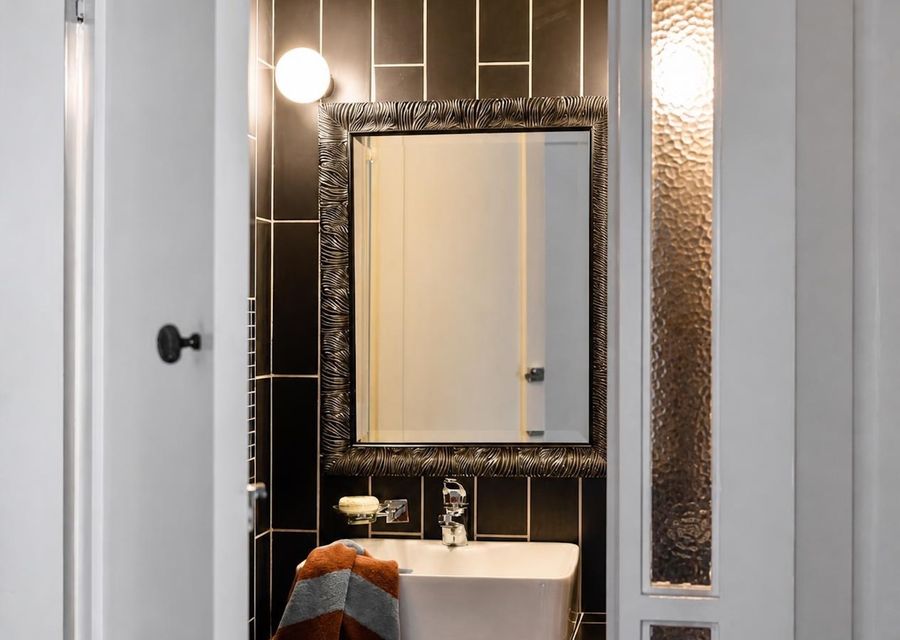 Stylish bathroom with striking tiled feature wall