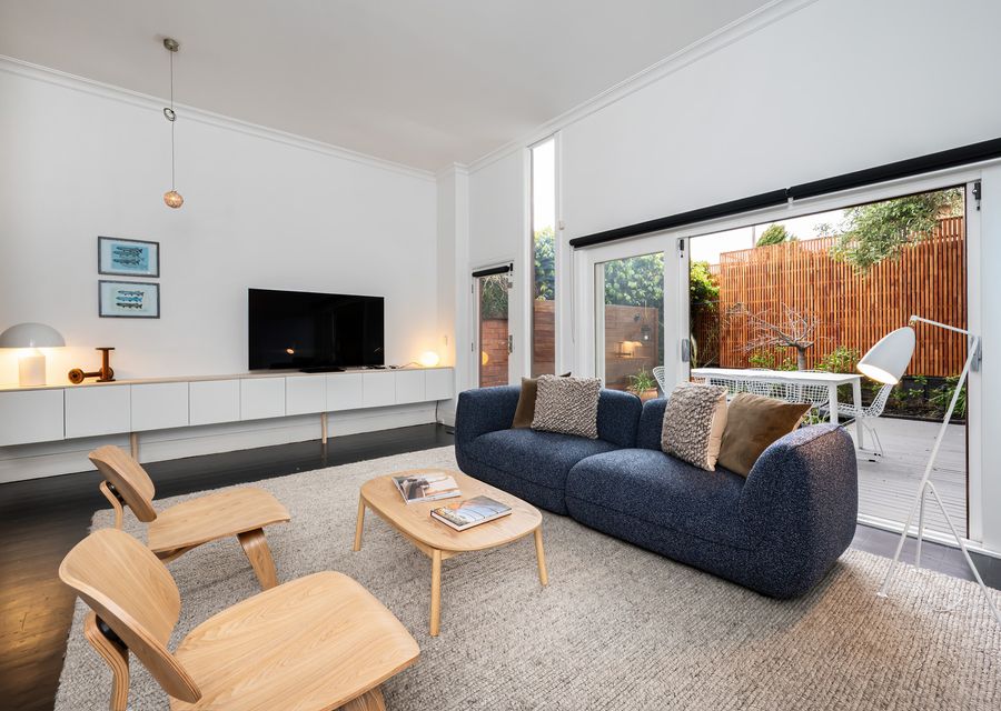 Main living area with smart tv and large doors onto courtyard